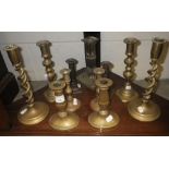 A pair of 19th century brass candlesticks and others similar