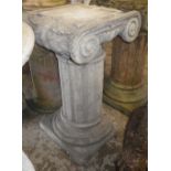 A reconstituted stone fluted column with acanthus decorated capital