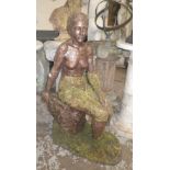 A reconstituted bronze effect naively cast study of a naked woman seated