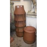 A terracotta chimney pot and another similar