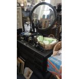 A 1920's oak dressing table, with barley-twist supports, together with a similar chest of drawers