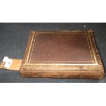 A Victorian leather covered photograph album, containing a quantity of photographs