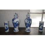 A pair of Oriental blue and white baluster vases with covers and a pair of similar cylinder vases