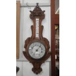 A Victorian oak aneroid barometer