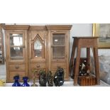 A pine hanging cupboard with an arrangement of drawers and glazed doors, with built-in American