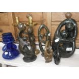 A pair of blue glass bulb vases, a pair of Gothic brass candlesticks and a collection of carved