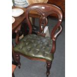 A Victorian style mahogany armchair with carved back, above button upholstered seat, on turned legs