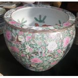 A Chinese famille rose jardiniere decorated with panels of figures and flowers 50" diameter