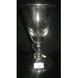 A large wine glass with tapering bowl with bubble included knop and spreading foot