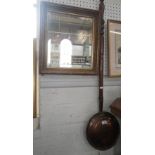 A copper warming pan and a gilt framed mirror