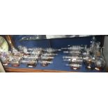 A large collection of blown glass ships in bottles