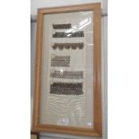 A collection of 19th century embroidery samples of trimmings in a maple frame