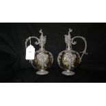 Two pale green glass flasks in pewter mounts