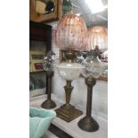 An Edwardian oil lamp (converted to electricity) with an original pink frosted shade and a pair of
