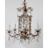 PATINATED METAL SIX-LIGHT CHANDELIER, H 30", DIA  27": Having a gold tone with crystal prisms.