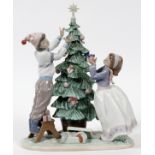 LLADRO PORCELAIN FIGURE GROUP, 'TRIMMING THE  TREE', #5897, H 13", W 10": A girl and boy  trimming