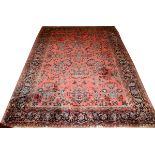 PERSIAN SAROUK HAND WOVEN RUG, W 8' 10" L 12'  2": Decorated in stylized floral motif on a  dark