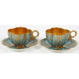 COALPORT FIRED GOLD PORCELAIN DEMITASSE CUPS &  SAUCERS, TWO SETS: A pair of hand decorated