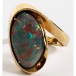 GOLD RING WITH OVAL OPAL: Gold setting.