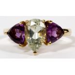 14KT YELLOW GOLD, AMETHYST AND PERIDOT RING:  having a pear shaped peridot flanked by two