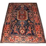 ANTIQUE KAZAK RUG, C. 1900, 5' 4" X 4' 0": A  blue field, red border, with an overall  geometric
