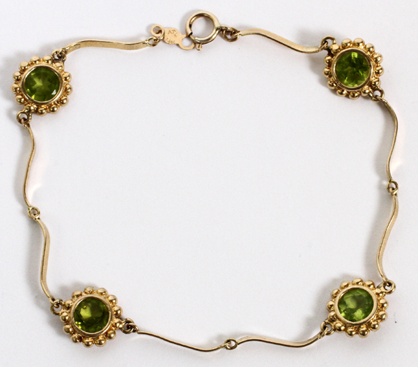 14KT YELLOW GOLD AND PERIDOT BRACELET, BY ATL, L  7": having four round cut peridots mounted in