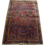 SAROUK WOOL RUG, W 4' 2", L 6' 2": Having a  plum ground with multi-colored designs.