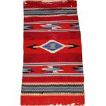 NAVAJO WOOL RUG, 3' 0" X 1' 7": Red field,  motif of arrows and geometric shapes.