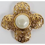 CHANEL FAUX PEARL BROOCH, W 2 1/2": Gold tone  brooch with pierced logo motif, centered by a  single