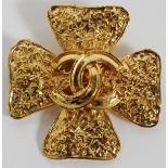 CHANEL GOLD TONE LOGO BROOCH, W 1 7/8": Gold  tone Maltese cross brooch with "Chanel" raised