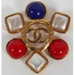 CHANEL FAUX PEARL & ENAMEL BROOCH, W 1 7/8":  Gold tone brooch with pierced logo at the  center,