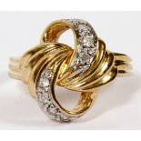 14KT YELLOW, WHITE GOLD & DIAMOND RING: With 8 enhanced diamonds in swirl form. TW.3.3 gr.