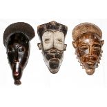 AFRICAN TRIBAL CARVED MASKS, 20TH C., THREE, H 14"-16": Including one Baule, Ivory Coast, mask,