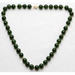 CHINESE JADE BEAD NECKLACE, L 18": Individually knotted dark green jade beads with a filigree