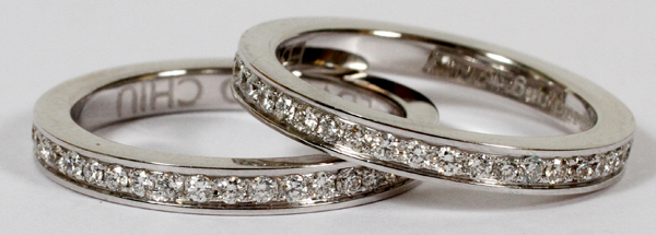 EDWARD CHIU, 1.50CT DIAMOND & GOLD, TWIN ETERNITY BANDS, SIZE 6: A pair of 18kt white gold