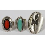 NAVAJO, TURQUOISE & CORAL STERLING RINGS, THREE: Including one sterling ring by Teddy Goodluck,