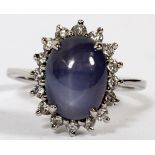 14KT WHITE GOLD, SAPPHIRE & DIAMOND RING: White gold. Natural star sapphire surrounded by round