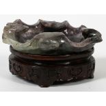 CHINESE CARVED AMETHYST LEAF ON ORIGINAL CARVED WOOD BASE, W 3 3/4", L 4 3/4": Inscribed "China"
