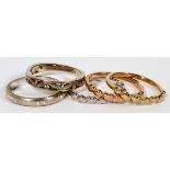 14KT WHITE GOLD & YELLOW GOLD BAND RINGS, FIVE: Totaling approximately 7 grams.