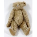 VINTAGE TEDDY BEAR, H 15": Jointed, hump at back, glass eyes, pad feet and paws. Circa 1910 - 1930.