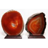 POLISHED AGATE SLICES, TWO, H 4 3/4", W 4 1/2": Each is mounted on a wood base.