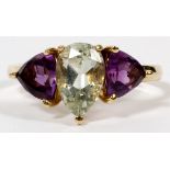 14KT YELLOW GOLD, AMETHYST AND PERIDOT RING: having a pear shaped peridot flanked by two