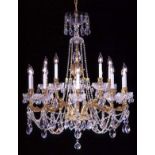 BRASS AND CRYSTAL FIFTEEN-LIGHT CHANDELIER H 40'', DIA 36'': A two tier brass arm chandelier with