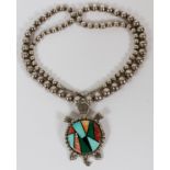 FRANK YELLOWHORSE, NAVAJO INLAID STONE & STERLING NECKLACE: A Navajo beaded necklace with turtle