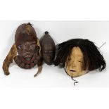 AFRICAN CARVED TRIBAL MASKS, THREE, L 8" & 11": Including one ovoid form mask, adorned with