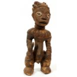 AFRICAN CARVED WOOD MALE FIGURE, H 17", CAMEROON: Depicted in a crouched, standing position.