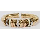 0.65CT DIAMOND & 18KT GOLD ROLLING RING BRACELET: An 18kt gold lady's bangle bracelet, featuring