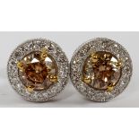 1.68CT FANCY YELLOW BROWN DIAMOND EARRINGS, PAIR: A pair of 14kt white gold stud back earrings, each