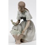 LLADRO BISQUE FIGURE OF A YOUNG WOMAN, H 10  1/2": A kneeling young woman depicted arranging  tulips