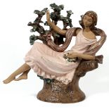 LLADRO GRES FIGURE, 'DAY DREAM FLORA', H 16", W  16", #2062: A young woman reclining in a tree.